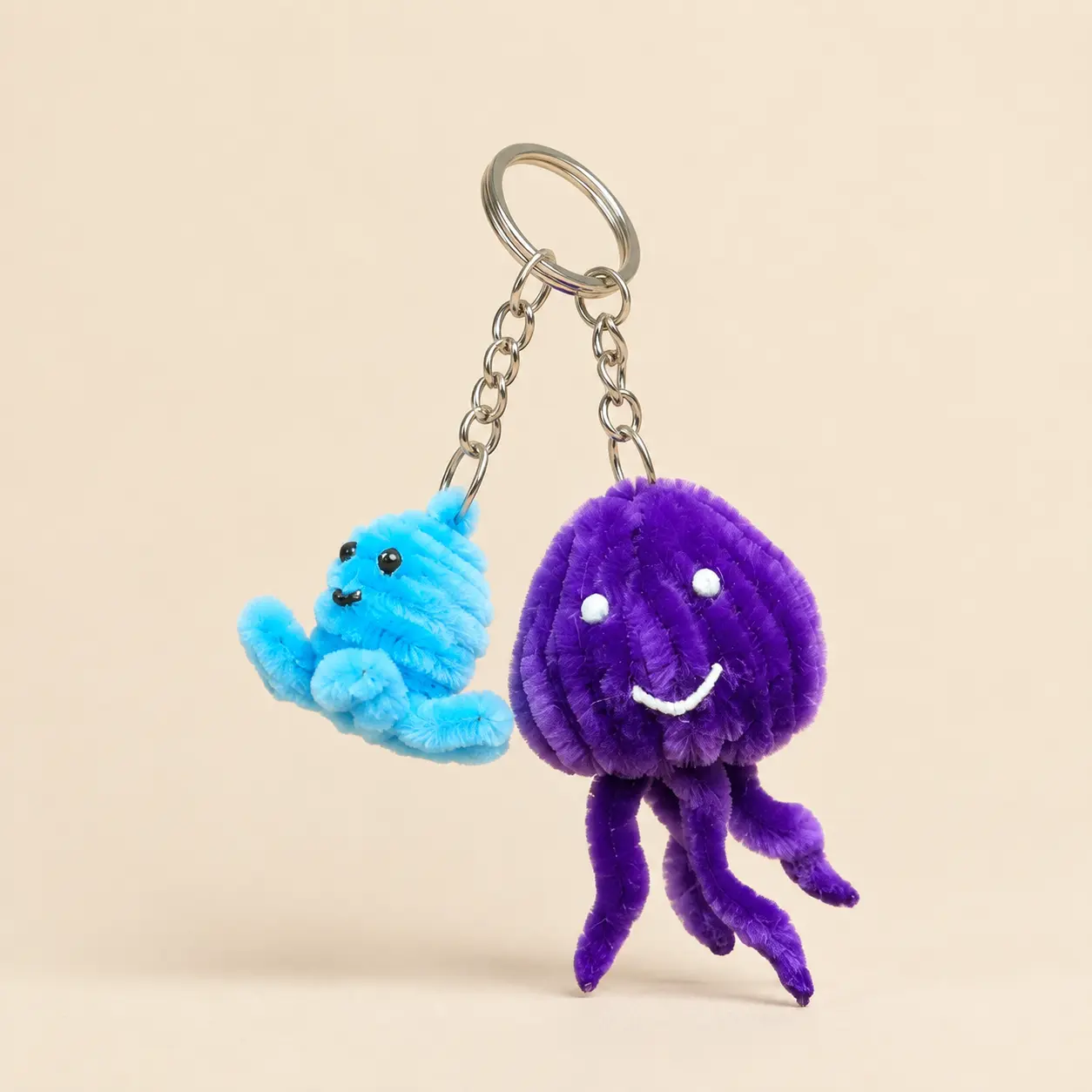 A bright pair of tiny handmade character charms.
